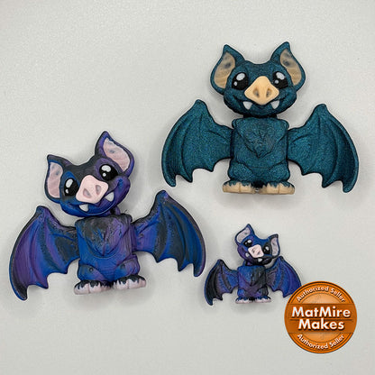 Shown with a micro mini version, these medium sized vampire bats are printed in dark blue-black filament.