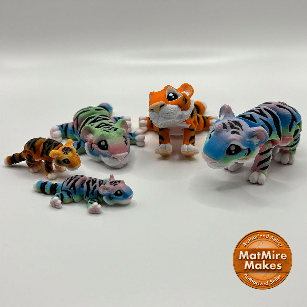 Colorful 3D printed tiger toys on a white background with 'MatMire Makes' logo.