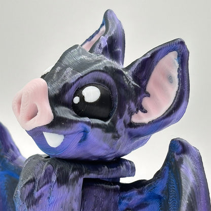 Close-up of a purple and black vampire bat fidget toy, 3D printed with silk pla.