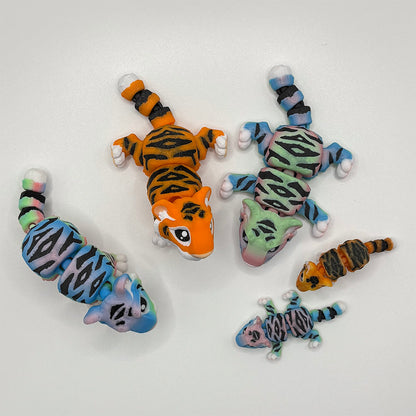 A selection of flexible 4 inch 3D printed tigers, pictured with micro-mini versions - available in rainbow or realistiv orange.