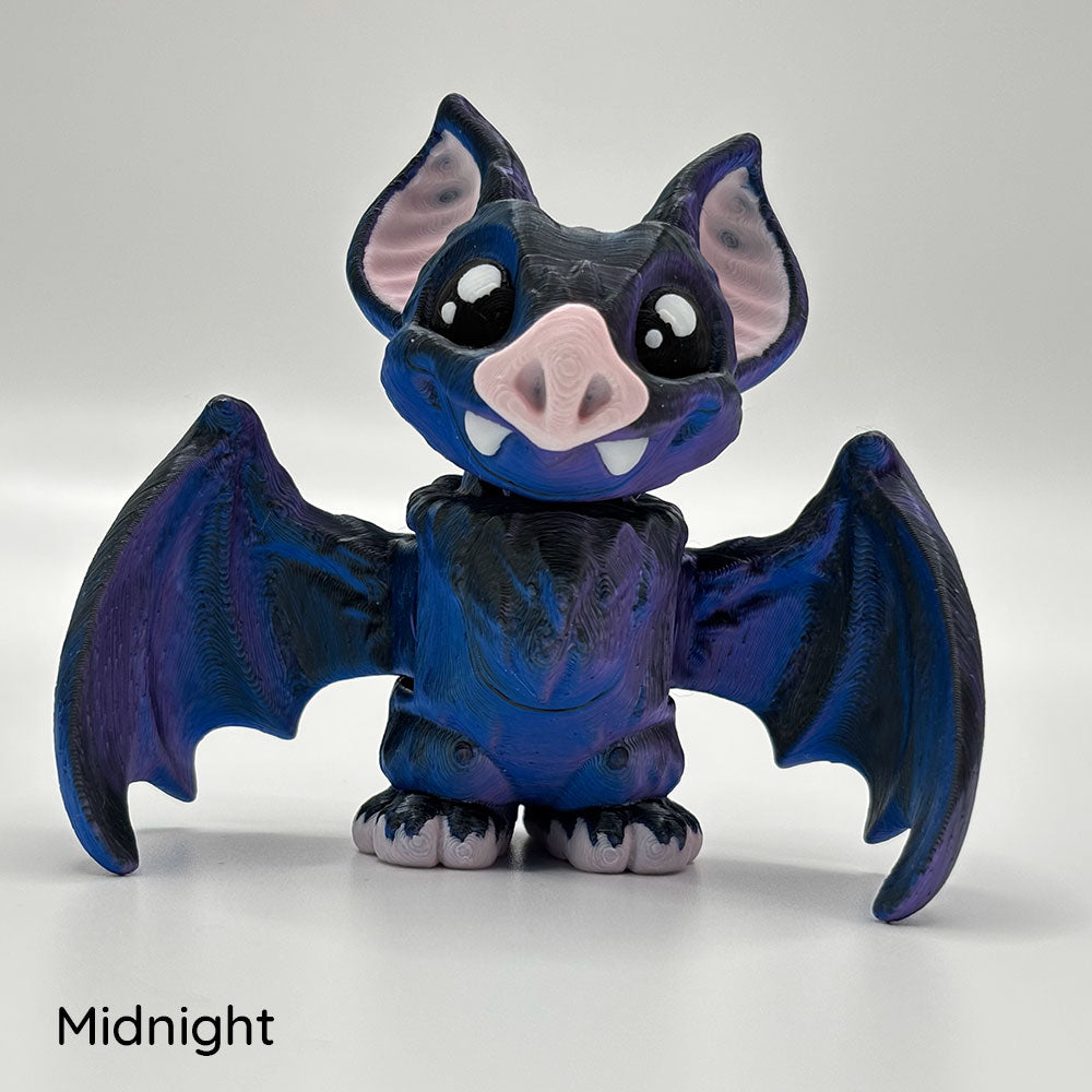 Toy figure of a 3D printed purple-black vampire bat with positionable wings and head.