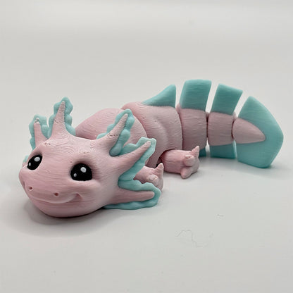 A cute, medium-sized axolotl with smiling face - 3D printed in biodegradable pink and mint green pla plastic filament
