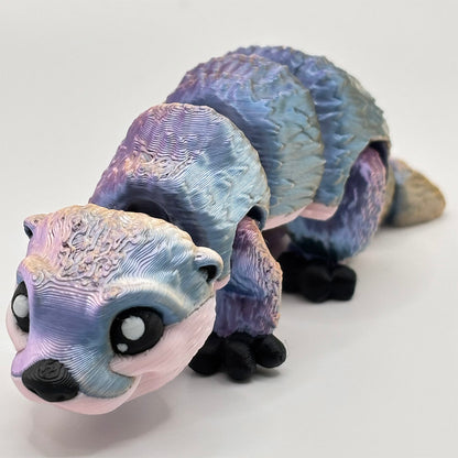 Flexible 3D printed otter pup with pink-purple colour shifting fur - design by MatMire Makes
