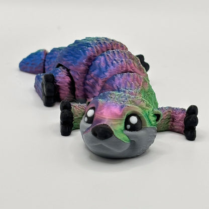 3D printed baby otter with multicoloured fur and a flexible segmented body for fidgeting hands
